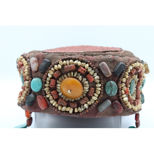 246 - Elegant Tibetan Hat: Adorned with Turquoise, Coral, Amber, and Agate

This Tibetan hat is a masterpi... 