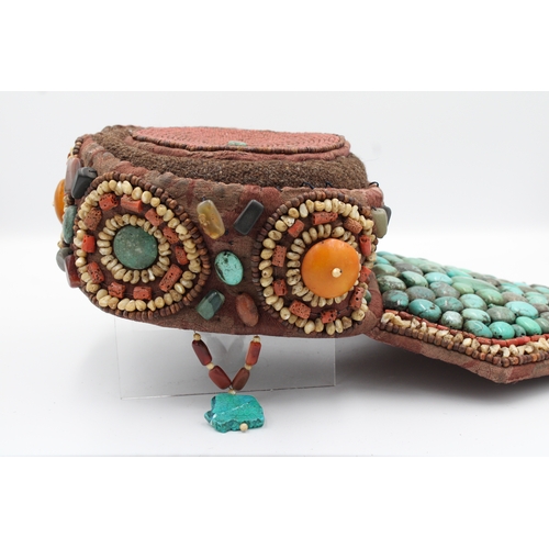 246 - Elegant Tibetan Hat: Adorned with Turquoise, Coral, Amber, and Agate

This Tibetan hat is a masterpi... 