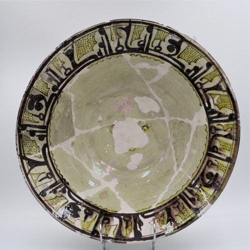 118 - This ceramic bowl, adorned with Kufic inscriptions and originating from Nishapur between the 10th an... 