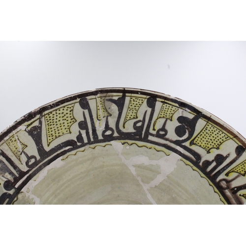 118 - This ceramic bowl, adorned with Kufic inscriptions and originating from Nishapur between the 10th an... 