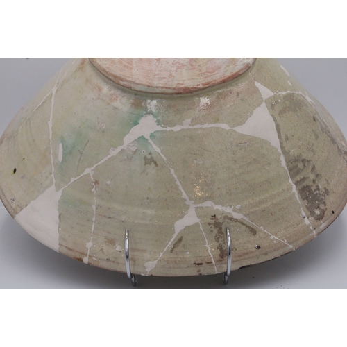 118 - This ceramic bowl, adorned with Kufic inscriptions and originating from Nishapur between the 10th an... 