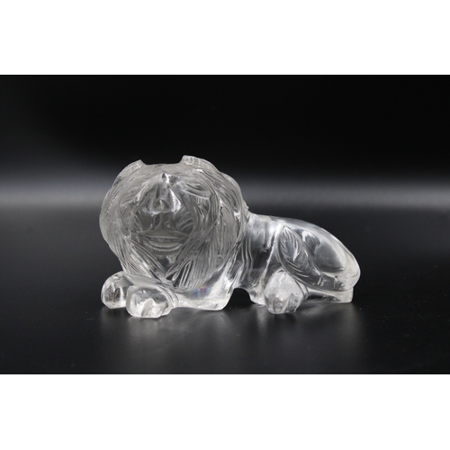 306 - Exquisite crystal or glass lion with intricate carvings, measuring approximately 7.5cm in width. A s... 