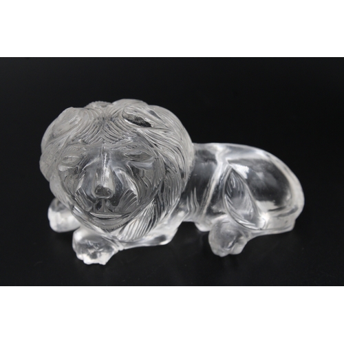 306 - Exquisite crystal or glass lion with intricate carvings, measuring approximately 7.5cm in width. A s... 