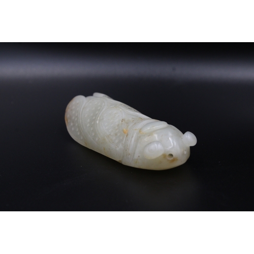 37 - This finely crafted Chinese cricket jade, originating from the late 18th to early 19th century (betw... 