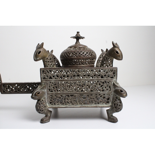 125 - Islamic bronze incense burner adorned with intricate openwork and delicate silver inlaid. This stunn... 