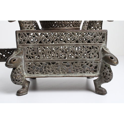 125 - Islamic bronze incense burner adorned with intricate openwork and delicate silver inlaid. This stunn... 