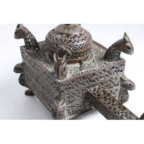 125 - Islamic bronze incense burner adorned with intricate openwork and delicate silver inlaid. This stunn... 