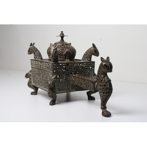 125 - Islamic bronze incense burner adorned with intricate openwork and delicate silver inlaid. This stunn... 