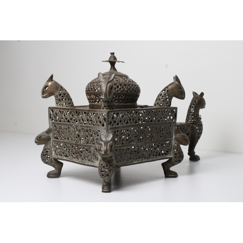 125 - Islamic bronze incense burner adorned with intricate openwork and delicate silver inlaid. This stunn... 