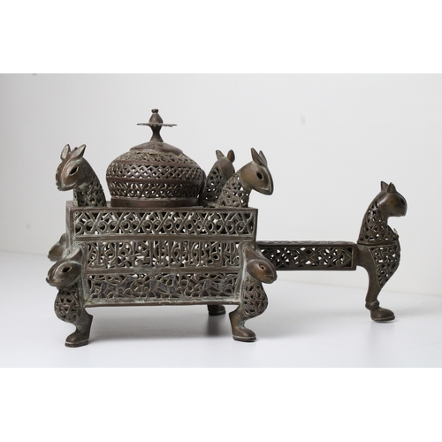 125 - Islamic bronze incense burner adorned with intricate openwork and delicate silver inlaid. This stunn... 