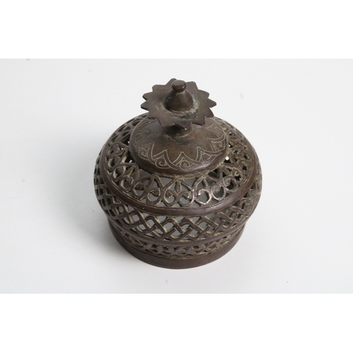 125 - Islamic bronze incense burner adorned with intricate openwork and delicate silver inlaid. This stunn... 