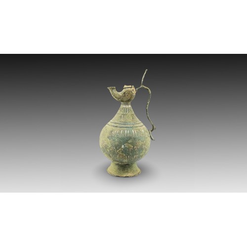 34 - An Islamic Bronze Jug with Silver Inlay from the 12th Century

Height: Approximately 31cm