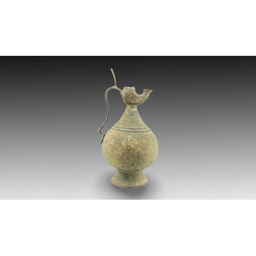 34 - An Islamic Bronze Jug with Silver Inlay from the 12th Century

Height: Approximately 31cm