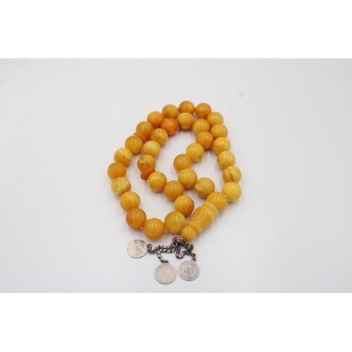 63 - An Islamic Large Butterscotch Amber Prayer Beads with White Metal Tassel  

Weight: 188g with White ... 