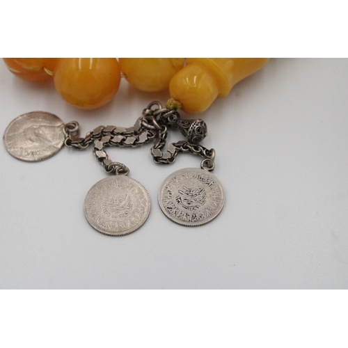 63 - An Islamic Large Butterscotch Amber Prayer Beads with White Metal Tassel  

Weight: 188g with White ... 