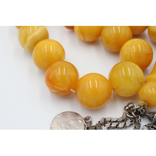 63 - An Islamic Large Butterscotch Amber Prayer Beads with White Metal Tassel  

Weight: 188g with White ... 