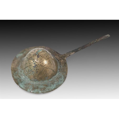 75 - An Islamic Ghaznavid Bronze Sieve from the 13th Century 

Length: Approximately 41.5cm
Diameter: App... 