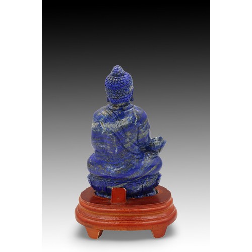 175 - A Chinese Hand Carved Lapis Lazuli Buddhist Statue, Complete with a Wooden Stand.

Height: Approxima... 