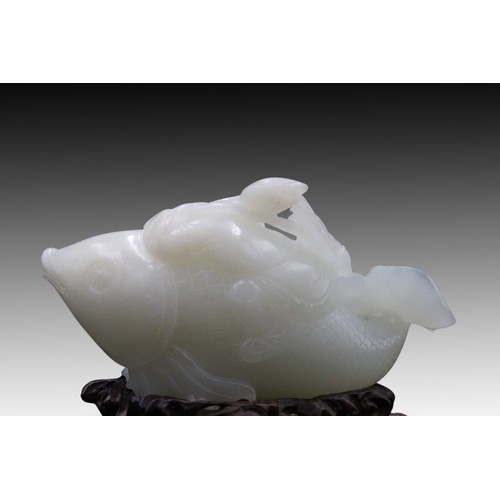 215 - A Chinese White Jade Carving from the Qing Dynasty of a Boy on Fish 

Private Collector in Belgium