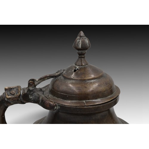 14 - An Islamic Mughal Bronze Teapot from the 19th Century with Intricate Carvings.

Height: Approximatel... 