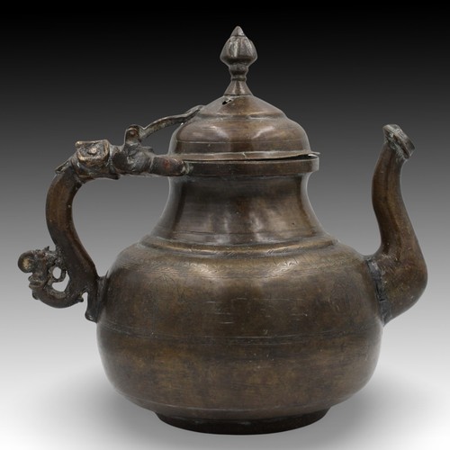 14 - An Islamic Mughal Bronze Teapot from the 19th Century with Intricate Carvings.

Height: Approximatel... 