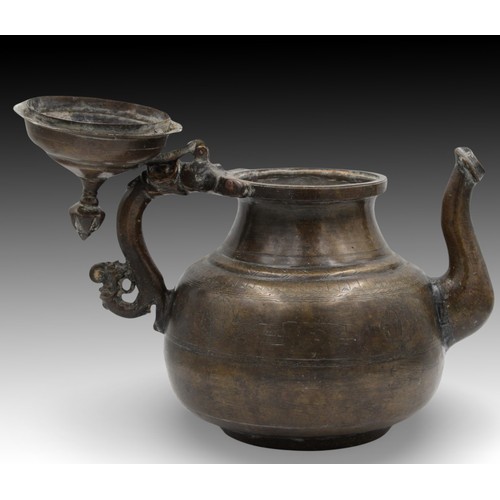 14 - An Islamic Mughal Bronze Teapot from the 19th Century with Intricate Carvings.

Height: Approximatel... 