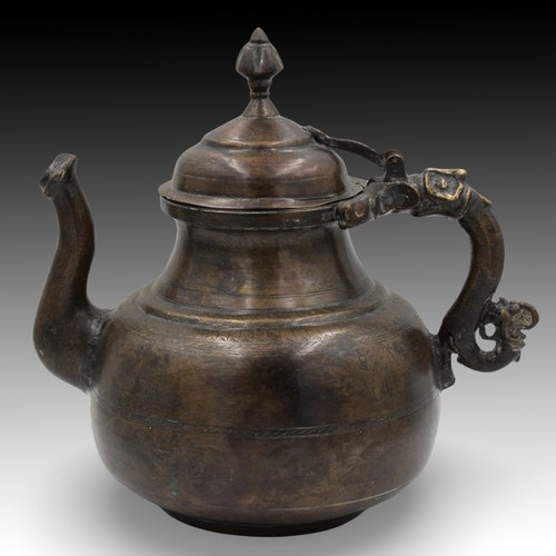 14 - An Islamic Mughal Bronze Teapot from the 19th Century with Intricate Carvings.

Height: Approximatel... 