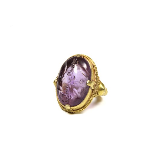 444 - An Amethyst Gold Ring with Islamic Inscription in the Style of the 12th-13th Century.

Ring Size: US... 