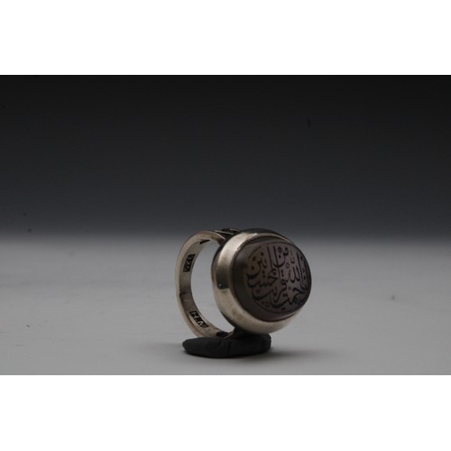 448 - An Islamic Silver Ring with Agate and Islamic Calligraphy.

Ring Size: UK24, US10.5