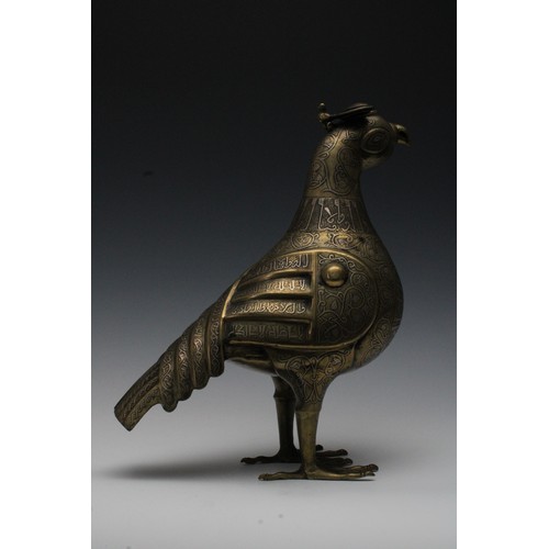 42 - An Islamic Bronze Incense Burner in the Shape of a Bird with Silver Inlay and Islamic Calligraphy.

... 