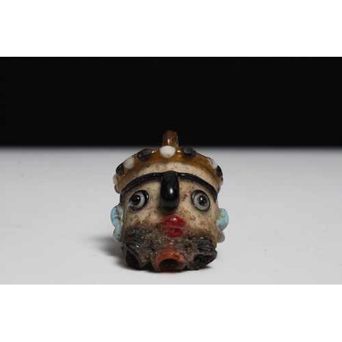 425 - A Glass Head Pendant in the Style of Roman or Phoenicia Levant Area.

H: Approximately 4.2cm