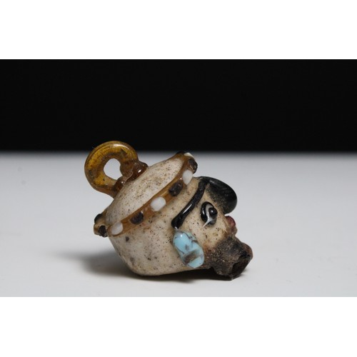 425 - A Glass Head Pendant in the Style of Roman or Phoenicia Levant Area.

H: Approximately 4.2cm