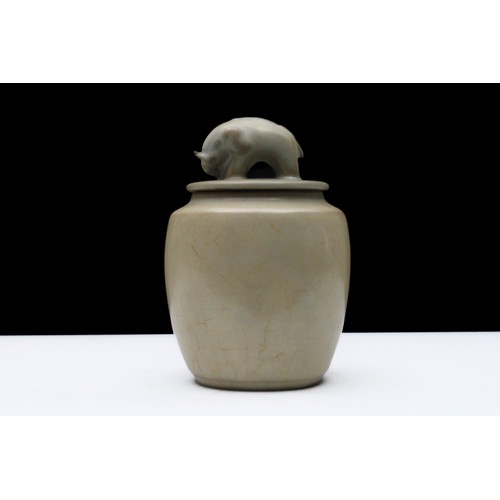 298 - A Chinese Celadon-Glazed Jar with an Elephant Carved on the Handle of the Lid.

H: Approximately 12c... 