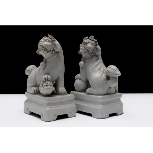 309 - A Pair of Chinese Porcelain Figures of Dogs with a Ball and a Puppy Under Their Feet. 

H: Approxima... 