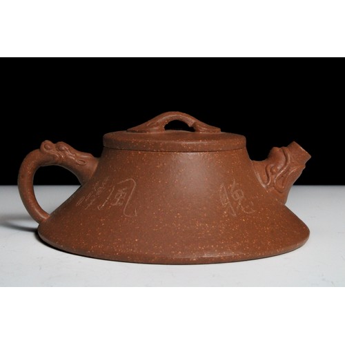 340 - A Chinese Yixing Zisha Flat Teapot with Chinese Inscriptions with Character Marks to the Base.

H: A... 