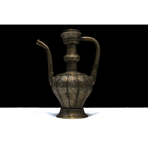 90 - An Islamic Khorasan Style Brass Ewer Aftaba with Silver Inlay Decorated with Kufic Calligraphy, Peop... 