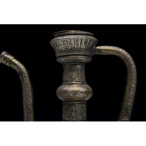 90 - An Islamic Khorasan Style Brass Ewer Aftaba with Silver Inlay Decorated with Kufic Calligraphy, Peop... 