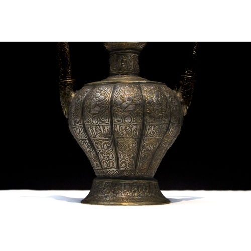 90 - An Islamic Khorasan Style Brass Ewer Aftaba with Silver Inlay Decorated with Kufic Calligraphy, Peop... 