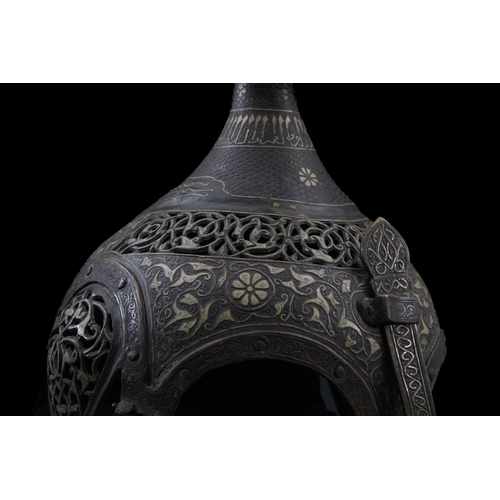 91 - An Indian Islamic Brass Helmet with Openwork in the Form of a Bird Decorated with Islamic Calligraph... 