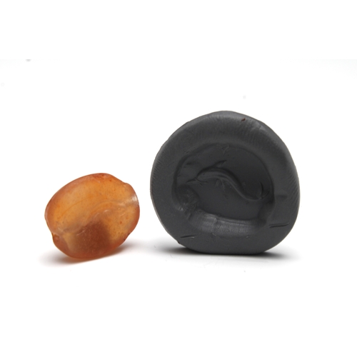 435 - A Greek Carnelian Scarab Gem Depicting a Dolphin.