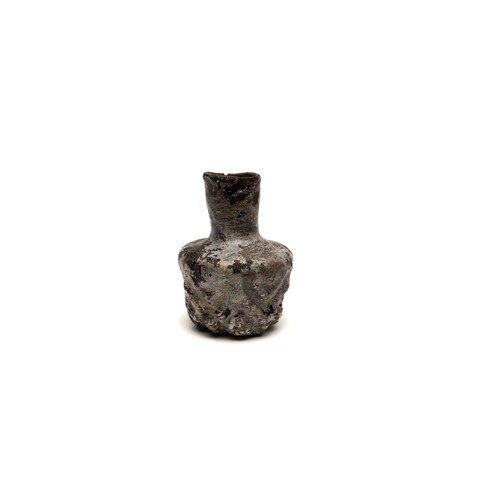 184 - An Islamic Dark Glass Bottle with Lovely Patina and Design from the 11-12th Century.

H: Approximate... 