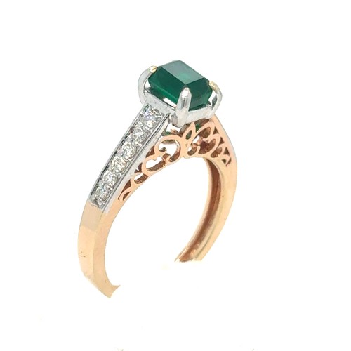 436 - An Emerald and Diamond Ring in Rose and White Gold.

Emerald Weight: Approximately 1ct
Stamped 14K 5... 