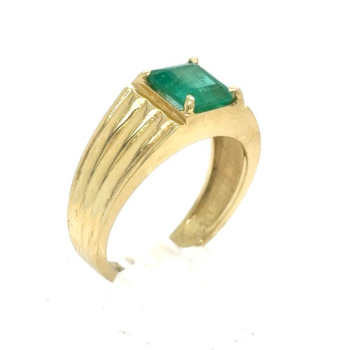 438 - An Emerald and Diamond Ring in Yellow Gold.

Emerald Weight: Approximately 1.75ct 
Stamped 18K
Ring ... 