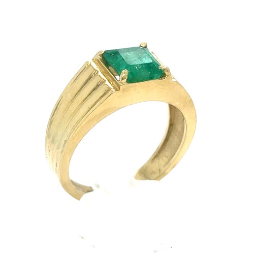 438 - An Emerald and Diamond Ring in Yellow Gold.

Emerald Weight: Approximately 1.75ct 
Stamped 18K
Ring ... 