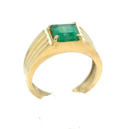 438 - An Emerald and Diamond Ring in Yellow Gold.

Emerald Weight: Approximately 1.75ct 
Stamped 18K
Ring ... 