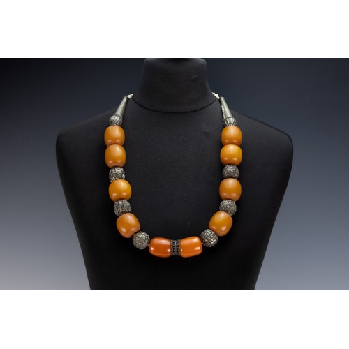 454 - A Tribal Yemeni White Metal Necklace with Amber Colour Beads.

196g