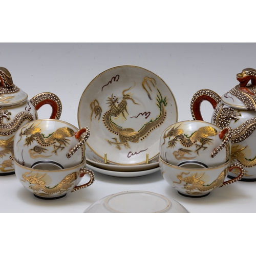 18 - A Japanese Tea Set Decorated with Dragons.

Includes:

4 Tea Cups with Saucers
1 Tea Pot
1 Sugar Pot