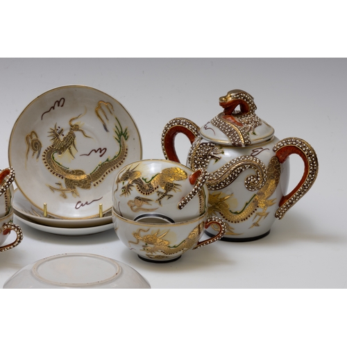 18 - A Japanese Tea Set Decorated with Dragons.

Includes:

4 Tea Cups with Saucers
1 Tea Pot
1 Sugar Pot