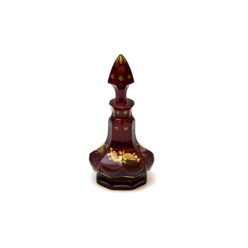 105 - An Antique Bohemian Dark Red Glass Perfume Bottle from the 19th Century.

H: Approximately 16cm