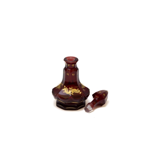 105 - An Antique Bohemian Dark Red Glass Perfume Bottle from the 19th Century.

H: Approximately 16cm